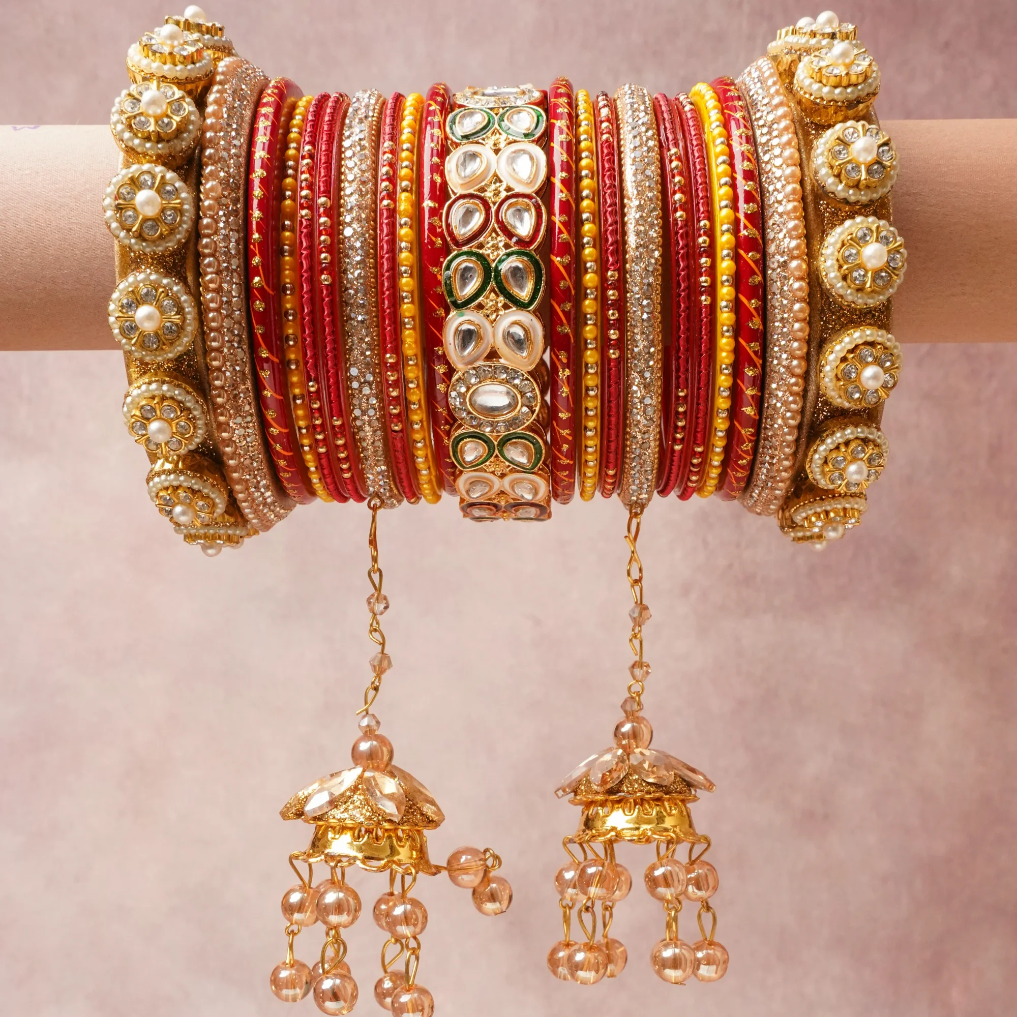 A majestic Gold set, complemented by Crimson Red, Ivory, Emerald Green, Champagne, Clear featuring Gold-toned Metal, Glass, Enamel, Faux Pearls, Kundan Stones, Cubic Zirconia.
Rich, ceremonial, and designed to be passed through generations.